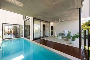 Unwind in your private poolside retreat, perfect for lazy afternoons.