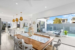 Enjoy breezy meals and sunset drinks in the stylish open-plan kitchen and dining area.