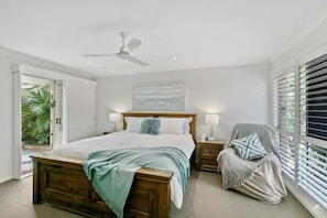 Retreat to the primary bedroom with king bed, walk-in robe, and a tranquil courtyard for peaceful mornings.