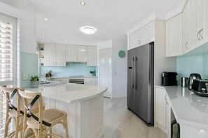 Cook, gather, and connect in the spacious family kitchen, designed with generous prep space and all the essentials for relaxed home dining.