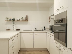 The kitchen is fully equipped and functional, with everything you need to cook at home.