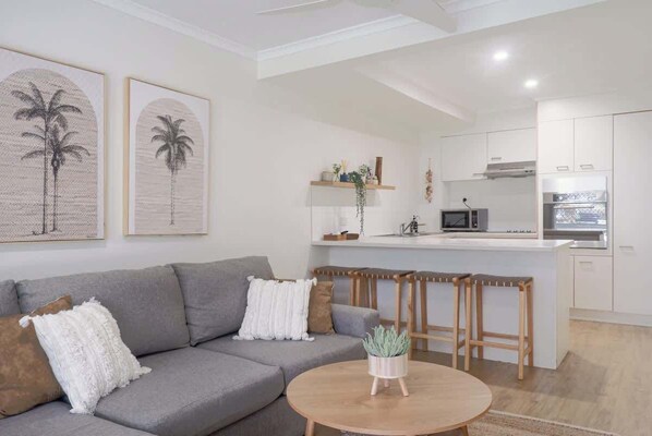 The charming lounge is a comfy coastal space to unwind after beach days.