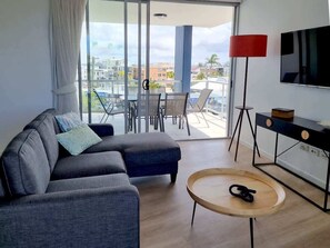 Bright, breezy and perfect for relaxing after a beach day, the living area includes a Smart TV and comfy seating for cosy nights in.