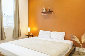Experience modern elegance in our carefully curated bedroom. The tasteful decor, paired with soft lighting, creates a serene atmosphere for a restful night's sleep
