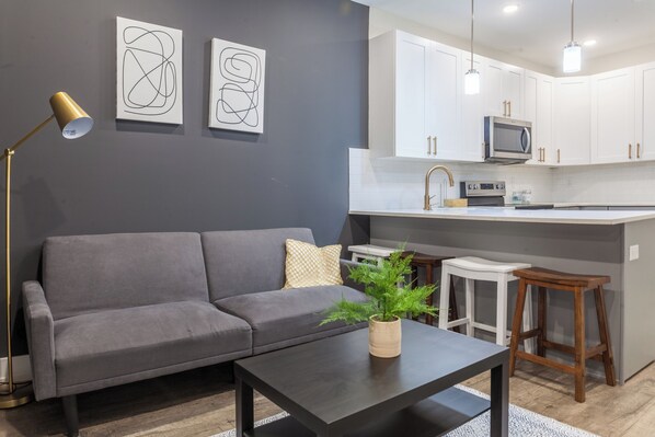 Unwind in our inviting living room, where the soft sunlight enhances the comfort of a cozy sofa couch, creating a serene retreat  #LivingRoomLuxury #ComfortAndStyle