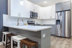Experience culinary freedom in our fully equipped kitchen, complete with pots, utensils, and pans for your cooking convenience #CulinaryCreativity #ThoughtfullyDesigned #CookingGoals