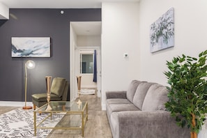 Relax in style in our chic living room adorned with modern furnishings and plenty of natural light #VibrantLiving #LivelyVibes #SocializingHub