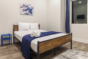Experience modern elegance in our carefully curated bedroom. The tasteful decor, paired with soft lighting, creates a serene atmosphere for a restful night's sleep