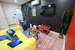 Step into a cozy and inviting living room designed for comfort and connection. With a plush sofa, stylish décor, and a large smart TV, it’s perfect for movie nights or relaxing after a long day. Warm lighting and soft tones create a welcoming space to unwind or catch up with friends.