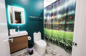A sleek and spotless bathroom designed for your daily rituals. Fresh towels, essentials, and calming vibes included