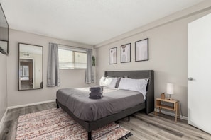Step into comfort and tranquility. This cozy bedroom offers a plush bed, soft linens, and a serene ambiance