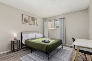 Step into comfort and tranquility. This cozy bedroom offers a plush bed, soft linens, and a serene ambiance
