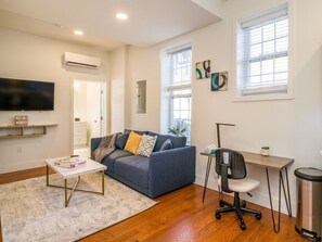 Comfy couch in the living room perfect for relaxing and chilling while watching your favorite show.