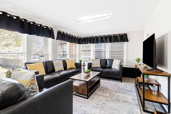 Living Room  1 - Unit 1 - Unwind & Watch – Comfortable seating with a Smart TV for entertainment.