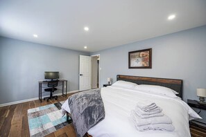 King sized bed with a computer table and monitor