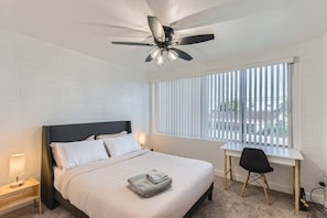 Queen memory foam mattress in the 2nd bedroom with desk and chair to work from home.