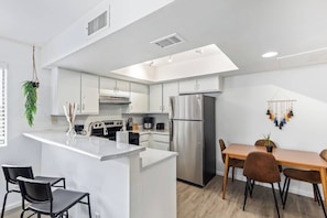 This stylish living room is perfect for entertaining or relaxing. The large open floor plan provides a spacious feel, while the comfortable couch and coffee table offer a place to unwind.