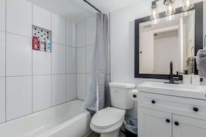 A sleek and spotless bathroom designed for your daily rituals. Fresh towels, essentials, and calming vibes included