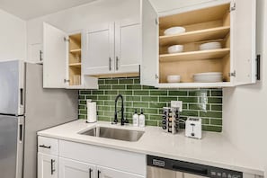 The well stocked kitchen has everything you need to cook a full meal including olive, oil spices, tin foil, coffee and more.