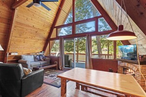 Gather, relax, and take in the views—floor-to-ceiling windows, a warm fireplace, and entertainment await.