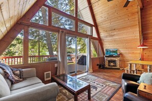 Bright, airy, and inviting—this living room features stunning windows, a fireplace, and Smart TV.