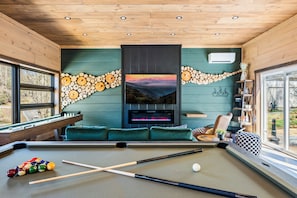 Kick back by the fireplace, shoot some pool, or stream your favorite show in this cozy-chic game lounge.