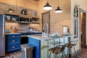Fully stocked kitchen with modern appliances, granite counters, and everything you need to cook and dine in comfort.