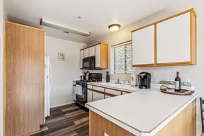 The inviting kitchen offers ample space & every home comfort