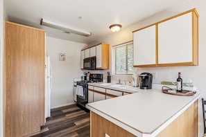 The inviting kitchen offers ample space & every home comfort