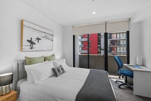 Drift off in the queen bed surrounded by calming tones, soft lighting, and direct access to the private balcony for the morning sun.