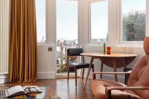 Dining area with large bay window access to terrace