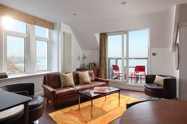 Living area with direct access to balcony and sea and castle views