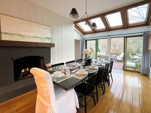 Cozy up by the crackling fire in  the dining table with seating for 10, an additional 4 at the bar and more seating outside on the spacious deck with views of the river.