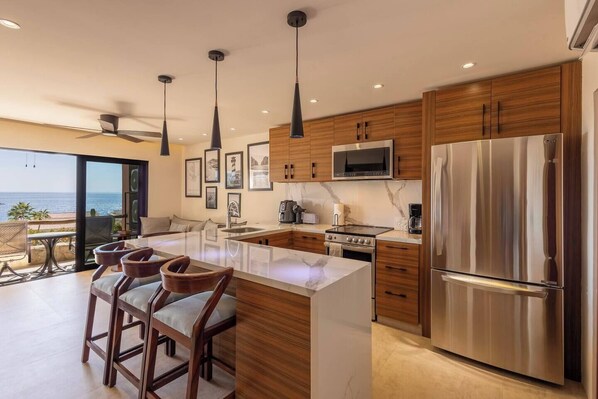 Enjoy the fully equipped kitchen with water and a view of the ocean while you cook.