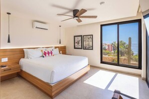 The master bedroom has a king bed. On your right there is a TV with Roku, and a sliding glass door to enjoy the patio