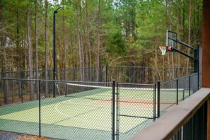 Private fenced pickleball and basketball court