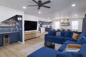 Bright, spacious retreat with a stylish blue sectional and bar for entertaining!