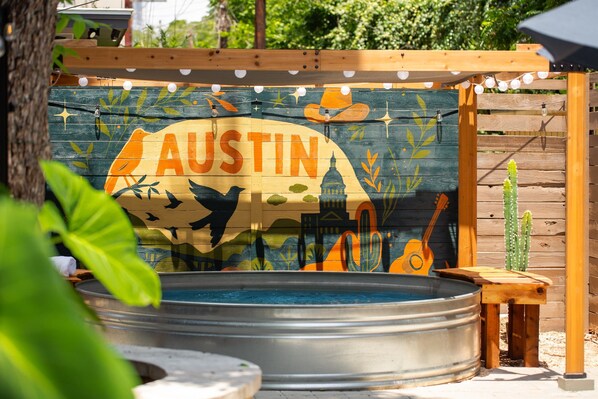 Refresh in a chic soaking tub surrounded by vibrant Austin art and greenery!