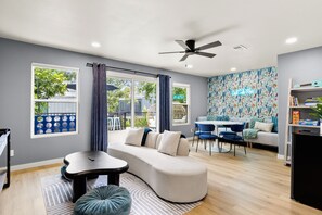 The upper floor boasts an entertaining game room with many fun amenities and relaxing spaces.