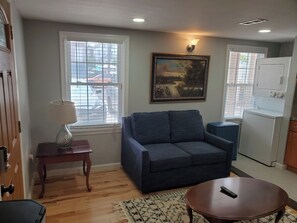 Living Room Area featuring Smart TV w/ Washer & Dryer tucked in the corner, to use at your convenience