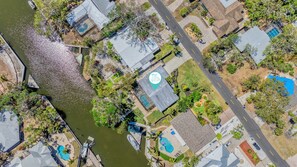 Aerial View of home. View of canal with the entire home in view as indicated.