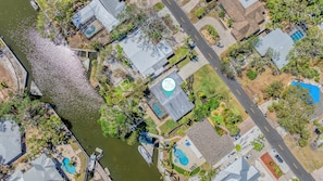 Aerial View of home. View of canal with the entire home in view as indicated.
