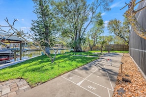 Full size shuffleboard court just outside the pool with canal views.