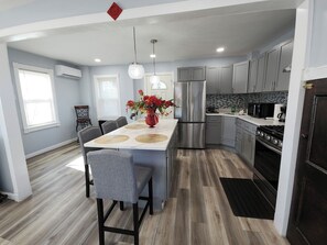 Newly updated kitchen with island and stainless steel appliances