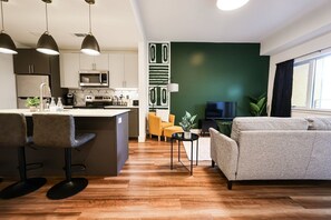 Modern living room with stylish furniture and decor, exemplifying contemporary interior design. The open layout seamlessly connects the living area to other parts of the space, creating an inviting atmosphere