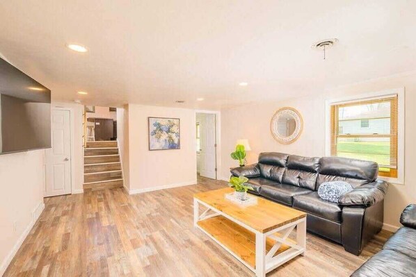 Living room features 2 couches along with a smart tv. 