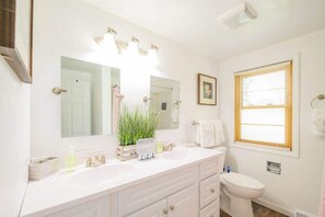 Bathroom features a double sink counter top with a full sized shower with tub. Plenty of extra towels available. We provide shampoo, conditioner, and soap, no need to bring your own. 