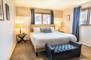 Relax in the serene master bedroom featuring a plush king-sized bed, stylish dresser, soft bedside lamps, and cozy bathrobes. Designed for comfort and rest, it’s the perfect retreat after a long day.
