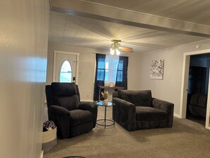 Living room features recliner, loveseat, and couch for sitting