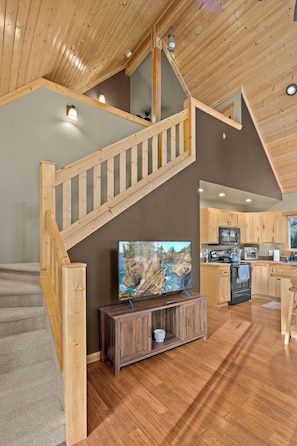 Living room + stairs to loft. Entertainment center with Smart Samsung TV, board games and children’s books.